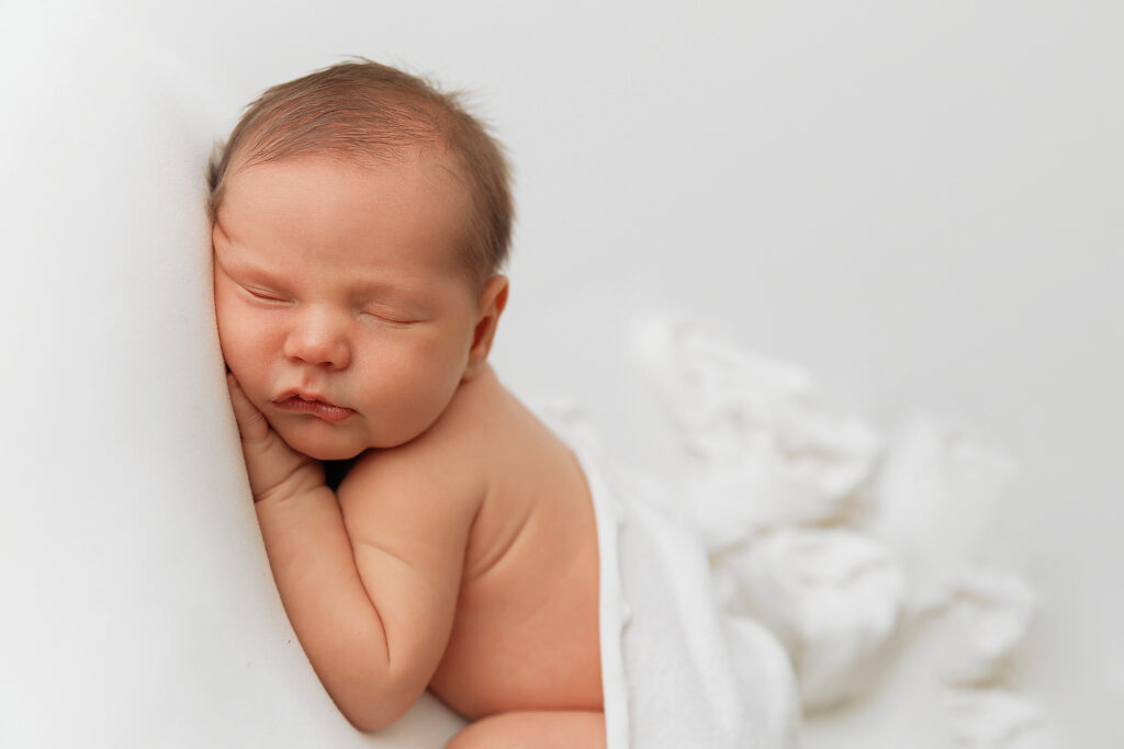 baby boy on all white in Claremore newborn photography studio 