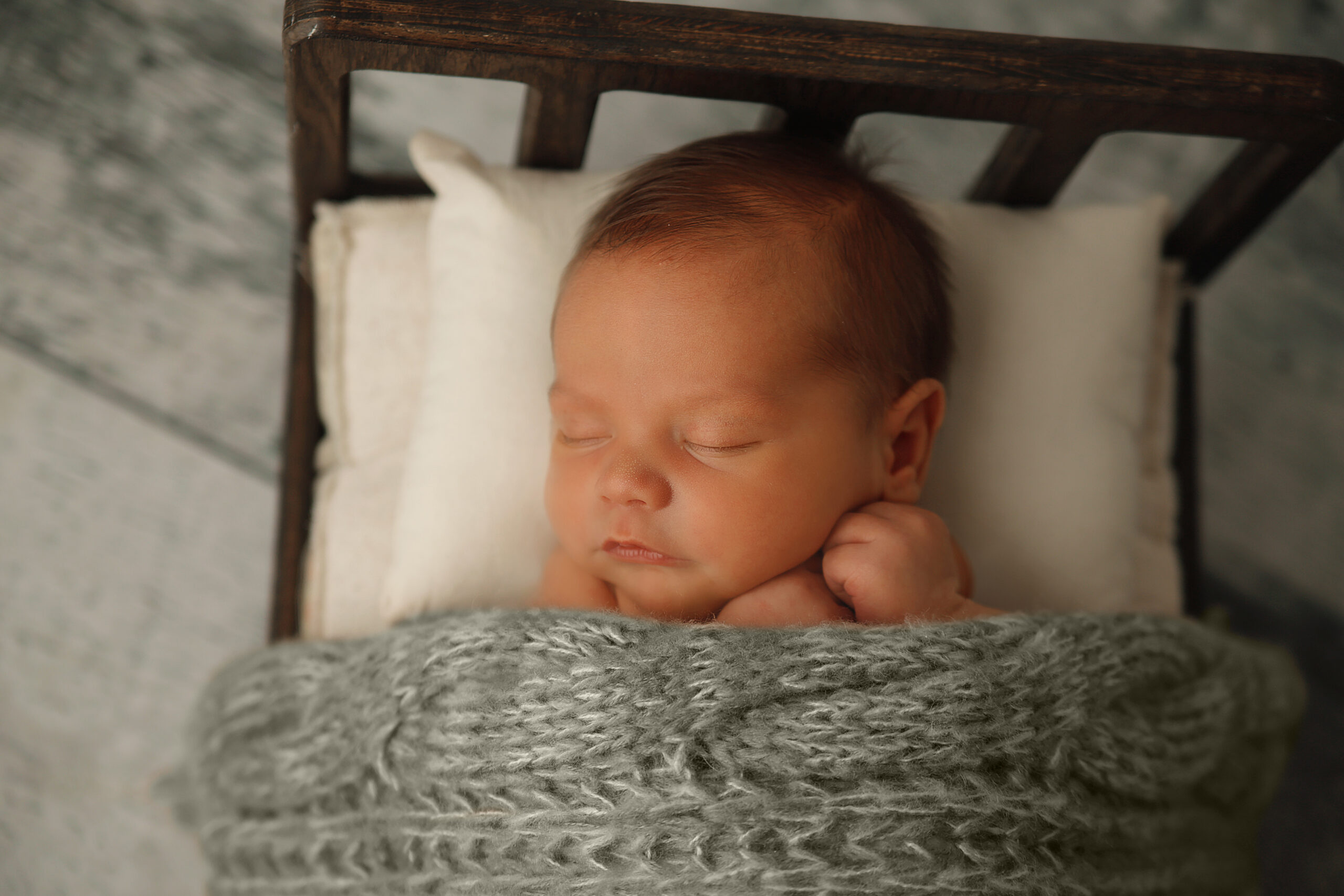 baby boy sleeping in little bed in  