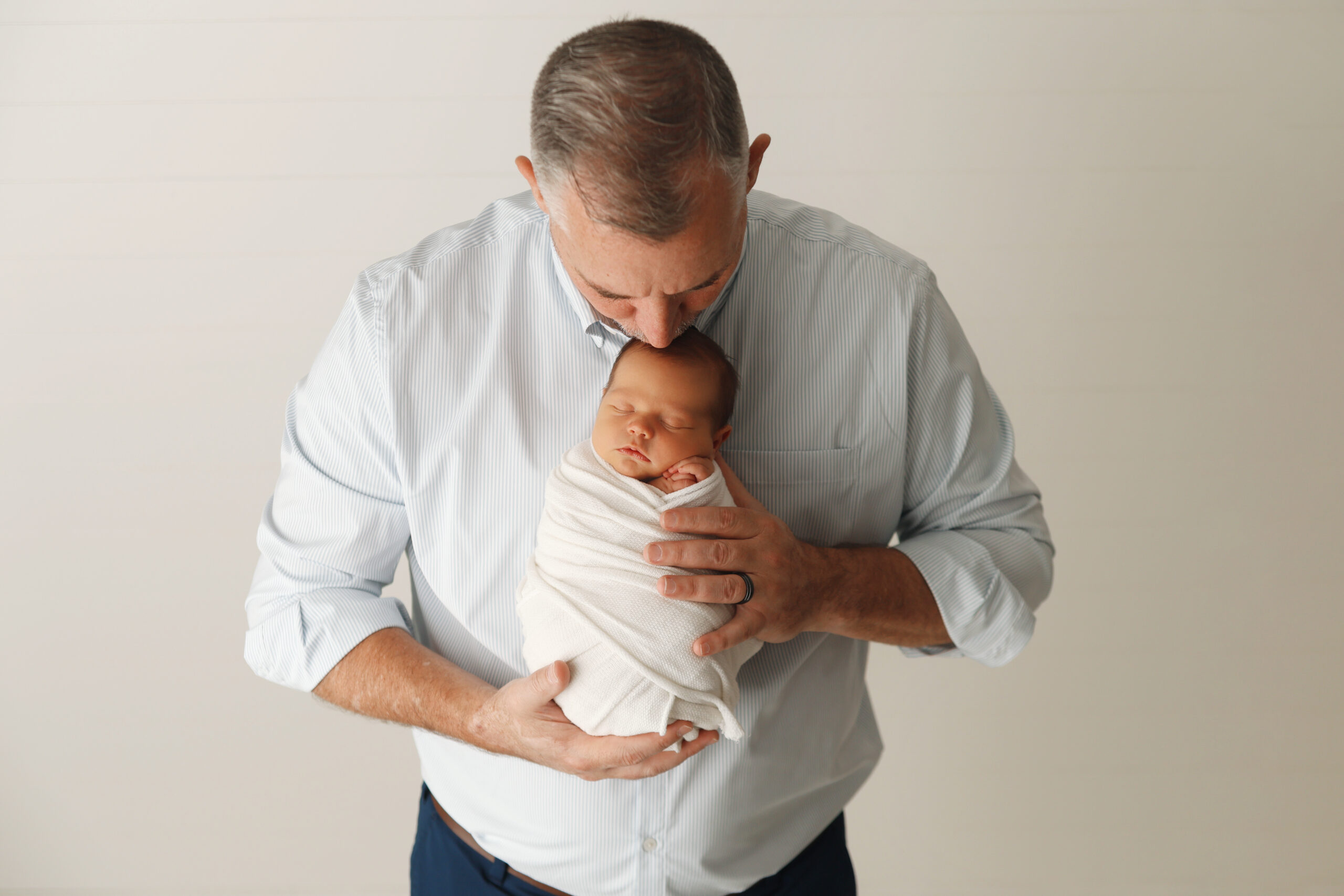 dad holding baby boy in 