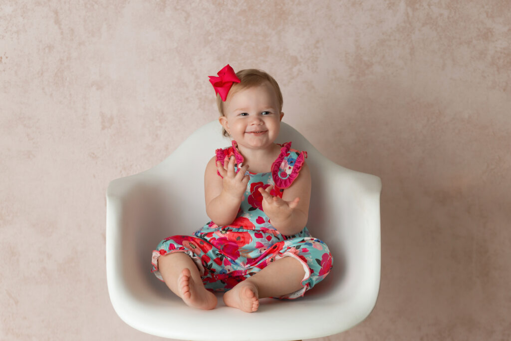 little girl with pink background in Clarmore newborn photography studio